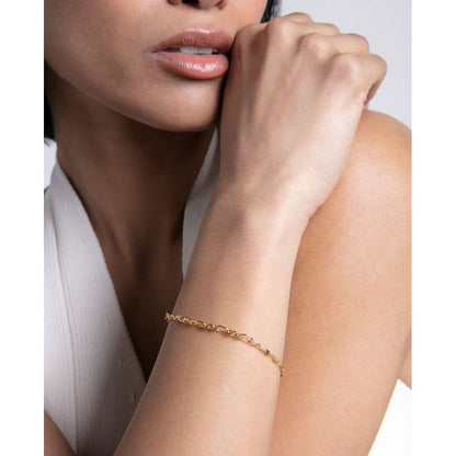 Elegant lady wearing a gold bracelet, showcasing the sleek design and chic style of the jewelry accessory.