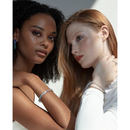 Two models showcasing elegant silver 925° bracelets from the VICEROY JEWELS Mod. 2326P000-30 collection in natural light.