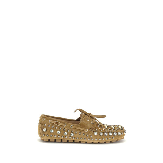 Valentino Garavani Beige Calf Leather Bos Taurus Slip-On Loafers with studs and rhinestones, showing a bold, contemporary style.