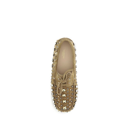 Valentino Garavani Beige Calf Leather Bos Taurus Slip-On Loafers with studs and rhinestones, top view of stylish and sophisticated design.