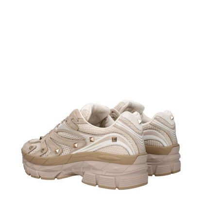 Valentino Garavani Beige Fabric Low Top Sneakers with studs, featuring front and back logos, rubber sole, round toe, and lace-up closure.