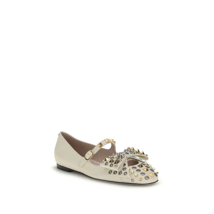 Valentino Garavani Cream Goatskin Ballet Flats with studs and bow detail, featuring adjustable buckle strap and antique-effect finish.
