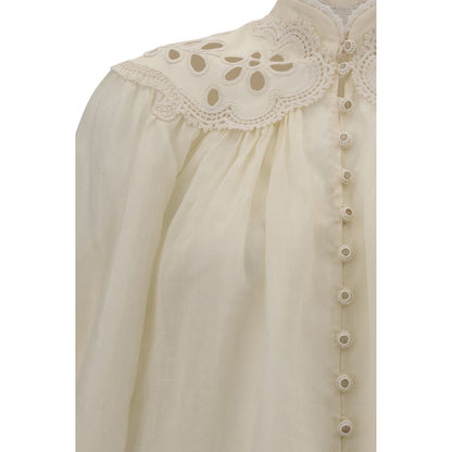 Close-up of the Zimmermann Cream Ramie Blouse showcasing scalloped hem, lace inserts, and elegant buttons.